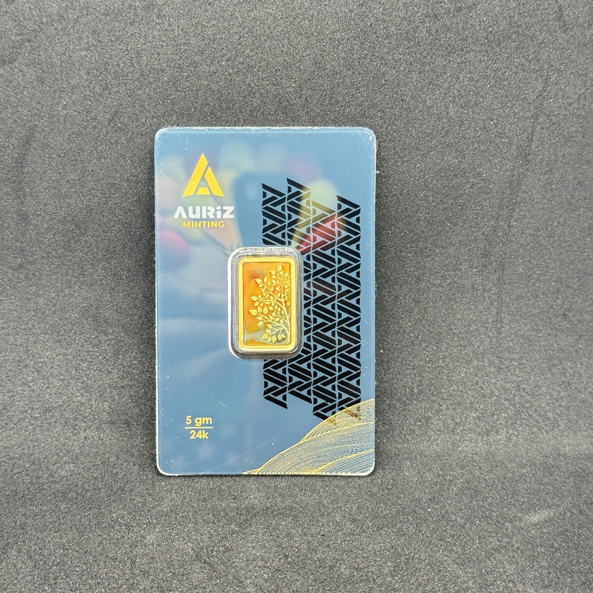 Card with a gold bar design on a gray surface